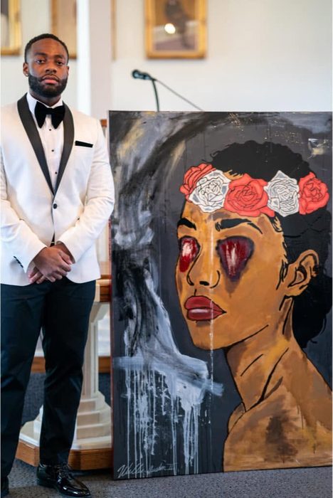 Willie Austin in a white dinner jacket and black bow tie, standing beside Sightless Bride, a painting of a woman in a crown of roses with red, bleeding eyes